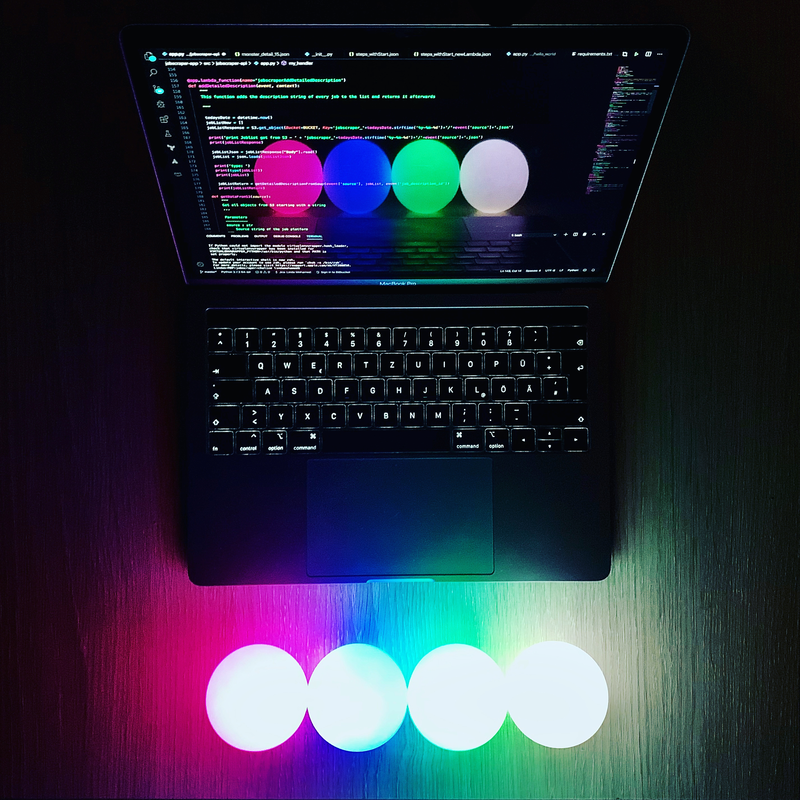 Laptop with glowing juggling balls